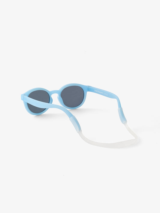 The back of a blue pair of baby sunglasses showing a silicone strap