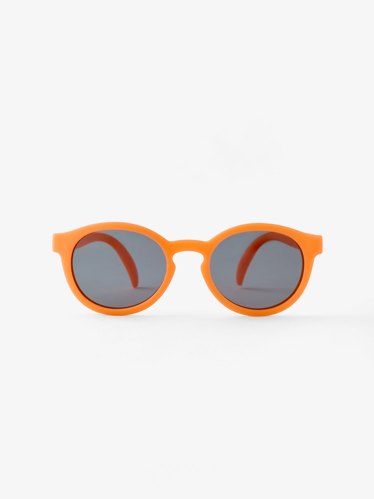 Round pair of baby sunglasses in orange showing the front view