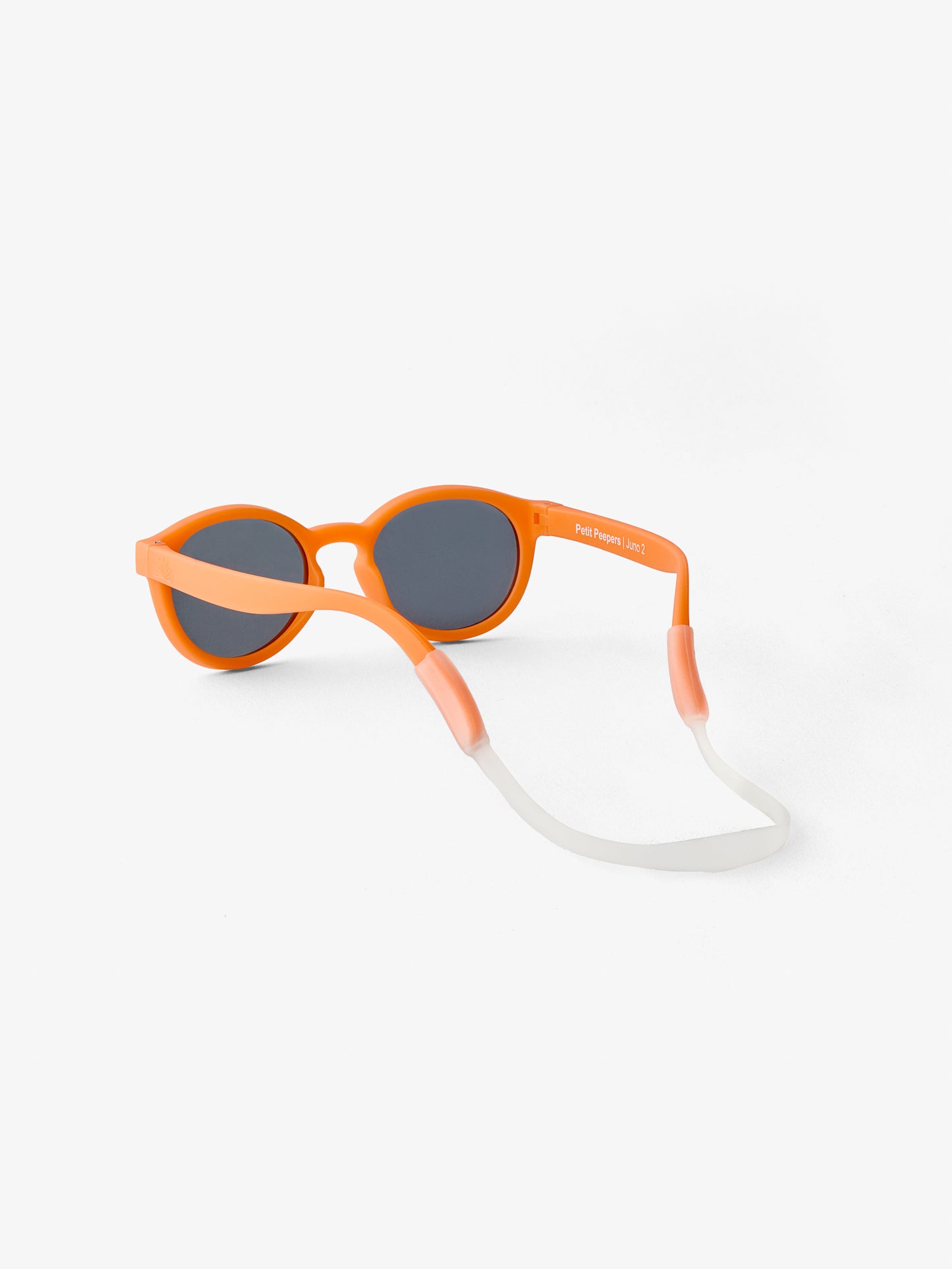 Back view of round baby sunglasses in orange with silicone strap
