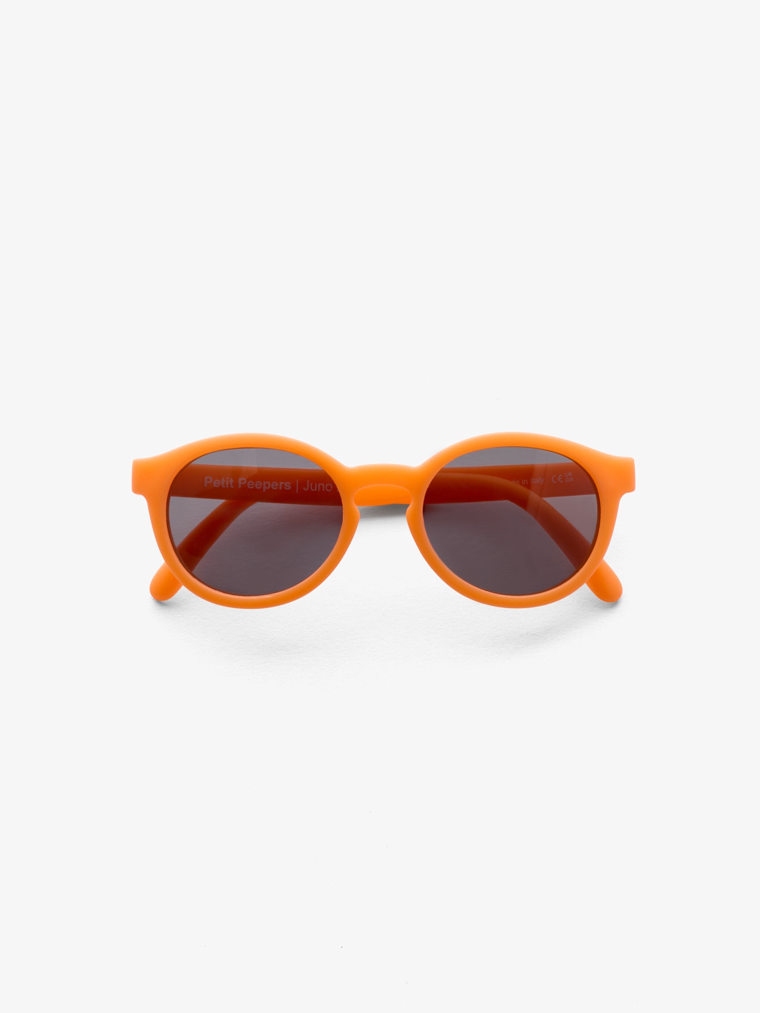 Folded pair of round orange baby sunglasses by Petit Peepers