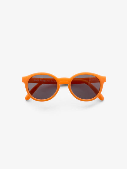 Folded pair of round orange baby sunglasses by Petit Peepers