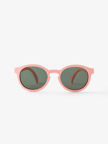 Front view of pair of round pink baby sunglasses by Petit Peepers